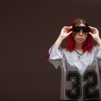Pink hair girl in avantgarde style wearing sunglasses. High quality photo